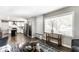 Open concept living room and kitchen featuring dark wood floors and natural light at 6491 N Oxford St, Indianapolis, IN 46220