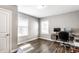 Office area features hardwood floors, neutral walls, and a built in desk area with cabinets at 6491 N Oxford St, Indianapolis, IN 46220