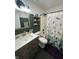 Stylish bathroom with dark green walls, modern fixtures, and a leaf-patterned shower curtain at 6588 Dunsdin Dr, Plainfield, IN 46168