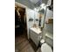 Bathroom features a white vanity with wood-look floors and closet at 6588 Dunsdin Dr, Plainfield, IN 46168