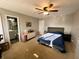 Bedroom featuring an en-suite bathroom, carpeted flooring, and natural lighting at 6588 Dunsdin Dr, Plainfield, IN 46168