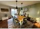 Charming dining room with a wooden table, unique wall decor, and a view of the backyard through sliding glass doors at 6588 Dunsdin Dr, Plainfield, IN 46168