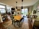 Open-concept dining room with a wooden table, hardwood floors, and easy access to the living room and backyard at 6588 Dunsdin Dr, Plainfield, IN 46168