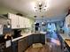 Open kitchen view includes updated appliances, wood floors, and breakfast bar at 6588 Dunsdin Dr, Plainfield, IN 46168