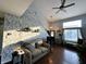Well-lit living room with hardwood floors, comfortable seating, and large windows that let in plenty of natural light at 6588 Dunsdin Dr, Plainfield, IN 46168