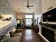 A bright and airy living room with a stone fireplace, large window, and staircase at 6588 Dunsdin Dr, Plainfield, IN 46168
