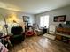 Cozy living room featuring hardwood floors, natural light, and comfortable seating arrangements at 6588 Dunsdin Dr, Plainfield, IN 46168