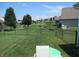 Spacious backyard with garden, pond view, and well-maintained lawn at 7232 Moultrie Dr, Indianapolis, IN 46217