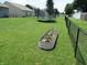 Spacious backyard featuring a garden, trampoline, and a black chain-link fence at 7232 Moultrie Dr, Indianapolis, IN 46217
