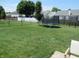 Large backyard with trampoline, level lawn, and fenced perimeter at 7232 Moultrie Dr, Indianapolis, IN 46217