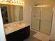 Bathroom with double sinks, a large mirror, and a glass-enclosed shower at 7232 Moultrie Dr, Indianapolis, IN 46217