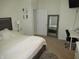 Neutral bedroom with a full-size bed, desk, full-length mirror, and carpet at 7232 Moultrie Dr, Indianapolis, IN 46217