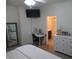 Well-lit bedroom features a ceiling fan, a workspace and an ensuite bathroom at 7232 Moultrie Dr, Indianapolis, IN 46217