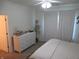 Bright bedroom features a ceiling fan, a large dresser, and natural light from the window at 7232 Moultrie Dr, Indianapolis, IN 46217