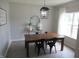 Charming dining room with a wooden table, stylish chairs, and modern lighting at 7232 Moultrie Dr, Indianapolis, IN 46217