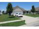 Charming single-story home with a white brick facade and a well-maintained lawn and driveway at 7232 Moultrie Dr, Indianapolis, IN 46217
