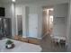 Bright, neutral hallway connects the kitchen to other rooms in the home at 7232 Moultrie Dr, Indianapolis, IN 46217