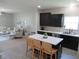 Spacious eat-in kitchen, with an island, flowing into a living room with comfortable furnishings at 7232 Moultrie Dr, Indianapolis, IN 46217