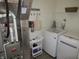 Laundry room with washer, dryer, utility sink, and storage shelves at 7232 Moultrie Dr, Indianapolis, IN 46217