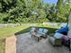 A backyard patio featuring outdoor furniture on a lush green lawn, enclosed by a white picket fence at 8323 Lake Tree Ln, Indianapolis, IN 46217