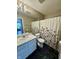 Bathroom featuring a large mirror, sink, and floral shower curtain at 8323 Lake Tree Ln, Indianapolis, IN 46217