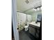 Well-lit bathroom featuring a white vanity, floral shower curtain, and modern fixtures at 8323 Lake Tree Ln, Indianapolis, IN 46217