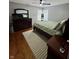 Comfortable bedroom with hardwood floors, a ceiling fan, and natural light from the windows at 8323 Lake Tree Ln, Indianapolis, IN 46217