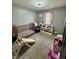 Bedroom featuring carpet, crib, small slide, and shelving units for toys at 8323 Lake Tree Ln, Indianapolis, IN 46217
