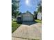 Traditional one-story home with a long driveway and well-maintained front lawn on a sunny day at 8323 Lake Tree Ln, Indianapolis, IN 46217