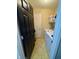 Small laundry room with a washer and dryer, utility sink, and storage shelves at 8323 Lake Tree Ln, Indianapolis, IN 46217
