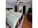 Spacious bedroom featuring a large bed, hardwood floors, and ensuite bathroom access at 8323 Lake Tree Ln, Indianapolis, IN 46217
