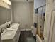 Bathroom featuring a double vanity with marble countertop and a tub with shower and curtain at 8423 Mud Creek Rd, Indianapolis, IN 46256
