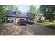 Spacious driveway with ample parking, showcasing a brick facade and a glimpse of the home's architecture at 8423 Mud Creek Rd, Indianapolis, IN 46256