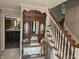 Inviting entryway with a carved wood table and staircase leading to the upper level of the home at 8423 Mud Creek Rd, Indianapolis, IN 46256