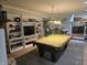 Entertainment space with a classic pool table, custom shelving, and comfortable seating at 8423 Mud Creek Rd, Indianapolis, IN 46256