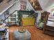 Unique attic living space with hardwood floors, a yellow dresser, and plenty of decor at 8423 Mud Creek Rd, Indianapolis, IN 46256