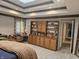 Spacious main bedroom featuring a tray ceiling, built-in shelving, and lots of natural light at 8423 Mud Creek Rd, Indianapolis, IN 46256