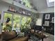 Sunroom featuring lots of light, many plants, and a door to the backyard at 8423 Mud Creek Rd, Indianapolis, IN 46256