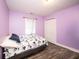 Comfortable bedroom featuring modern flooring, a double-door closet, and natural light from the window at 8514 Midsummer Dr, Indianapolis, IN 46239