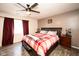 Cozy bedroom with a ceiling fan, wood floors, and a comfortable queen-sized bed at 8514 Midsummer Dr, Indianapolis, IN 46239