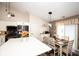 Kitchen and dining area with wood floors, white cabinets, and modern appliances at 8514 Midsummer Dr, Indianapolis, IN 46239