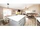 Open floor plan with kitchen island, dining area, and comfortable living room with a fireplace at 8514 Midsummer Dr, Indianapolis, IN 46239