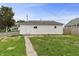 Back exterior featuring walkway, fencing, and partial lawn at 920 State St, Shelbyville, IN 46176