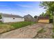 Back exterior featuring fencing, driveway and an outbuilding at 920 State St, Shelbyville, IN 46176