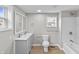 Bathroom with double vanity, toilet, and a bathtub with shower; all designed in a contemporary style at 920 State St, Shelbyville, IN 46176