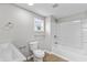 Well-lit bathroom featuring a toilet, white tile shower, and neutral wall color for a relaxing space at 920 State St, Shelbyville, IN 46176