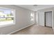 Bright bedroom features wood-look flooring, closet, and large windows at 920 State St, Shelbyville, IN 46176