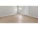 Bedroom with hardwood floors, beadboard walls, and a window offering plenty of natural light at 920 State St, Shelbyville, IN 46176