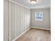 Bedroom with wood floors, a window for natural light and beadboard walls throughout the space at 920 State St, Shelbyville, IN 46176