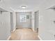 Hallway featuring wood-look flooring and bright lighting at 920 State St, Shelbyville, IN 46176